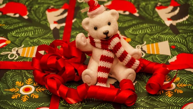 A cozy and warm Christmas scene showcasing an adorable polar bear surrounded by colorful decorative ribbons