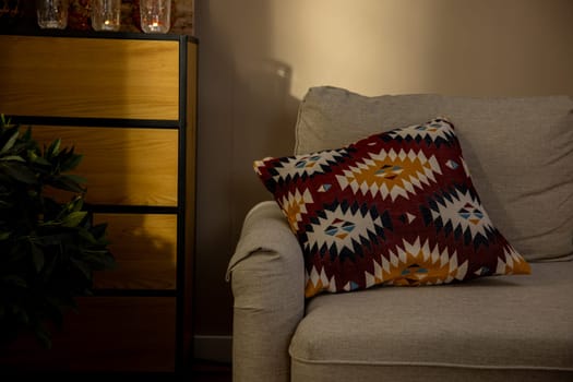 The stylish interior features a beautiful decorative cushion placed on a very comfortable sofa for relaxation