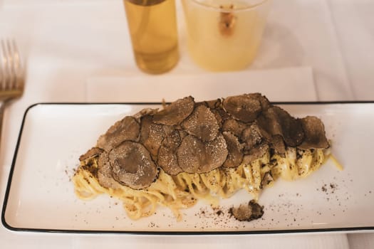 Italian pasta with truffle mushrooms in a restaurant