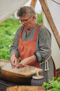 Hojbjerg, Denmark, July 27, 2024: Mature hostess at the Viking festival