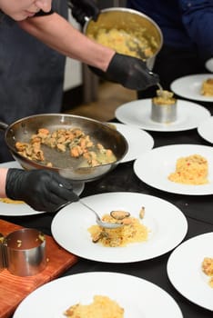 preparation of paella with chicken and mussels.