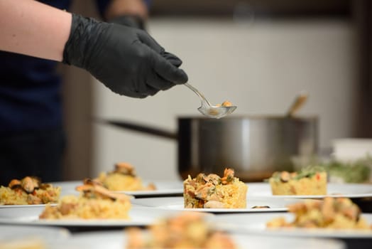 preparation of paella with chicken and mussels.