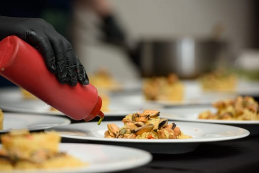 preparation of paella with chicken and mussels.