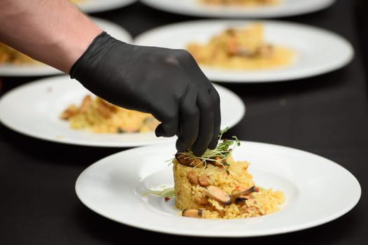 preparation of paella with chicken and mussels.