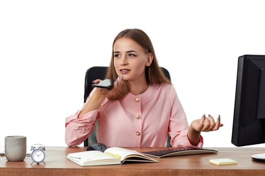 successful brunette business woman in pink shirt having phone conversation in office
