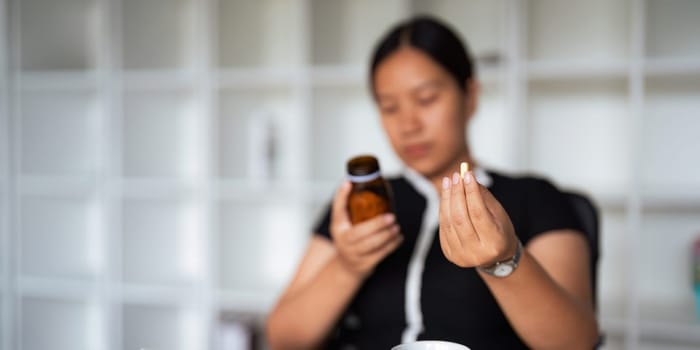 Close up woman holding pill in hand with water feeling sick. female going to take painkiller from headache, painkiller, healthcare, medicine, treatment, therapy, patient, disease illness concept.