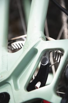 Close-up of a mountain bike element. Shallow depth of field frame detail and brake disc of mountain bike hydraulic brakes.