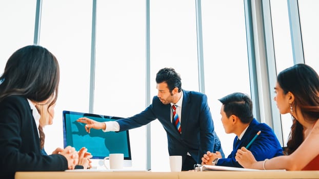 Business people in the conference room with green screen chroma key TV or computer on the office table. Diverse group of businessman and businesswoman in meeting on video conference call . Jivy