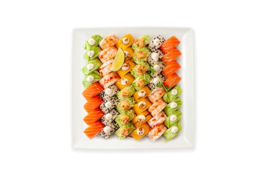 Assorted sushi big set on a white plate isolated. A variety of Japanese sushi with tuna, crab, salmon, eel and rolls. Top view. High quality photo.