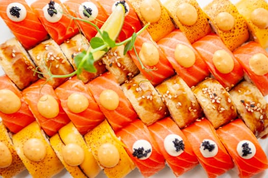 Assorted sushi big set close-up background. A variety of Japanese sushi with tuna, crab, salmon, eel and rolls. Top view. High quality photo