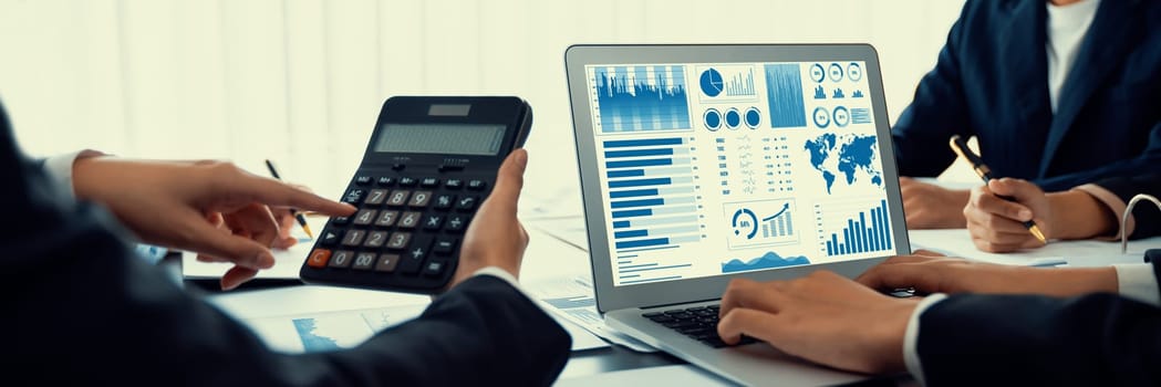 Business intelligence and data analysis concept. Analyst team working on financial data analysis dashboard on laptop screen as marketing indication for effective business strategic planning. Insight