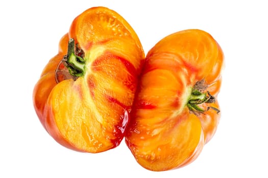 Studio shot of half yellow and orange tomatoes on white background
