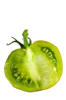 halved fresh green zebra tomato close up and tomatoes in the background