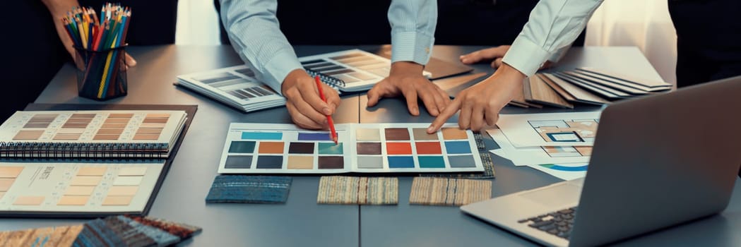 Group of professional interior designer and architect working together, planning and choosing color samples in office for house design or renovation. Insight