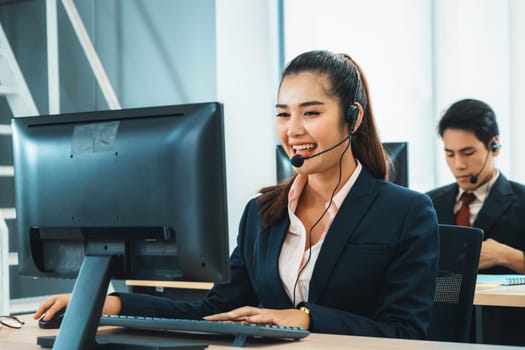 Business people wearing headset working in office to support remote customer or colleague. Call center, telemarketing, customer support agent provide service on telephone video conference call. Jivy