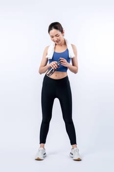 Athletic and sporty asian woman resting and drink water after intensive cardio workout training. Healthy exercising and fit body care lifestyle pursuit in studio shot isolated background. Vigorous