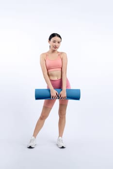 Young attractive asian woman portrait in sportswear with exercising mat. Healthy exercise and workout routine lifestyle concept. Studio shot isolated background. Vigorous