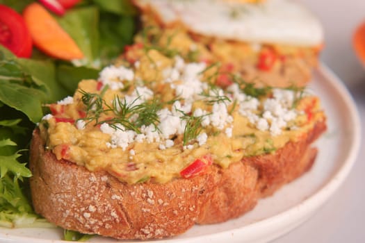 Tasty fresh toast with avocado and egg.