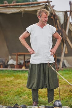 Hojbjerg, Denmark, July 27, 2024: Man in ancient clothing at a Viking festival