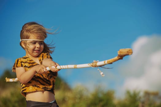 Cute baby dressed in the clothes of primitive people.