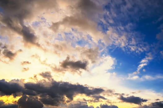 orange and blue background with cloudy sky with clouds at sunset