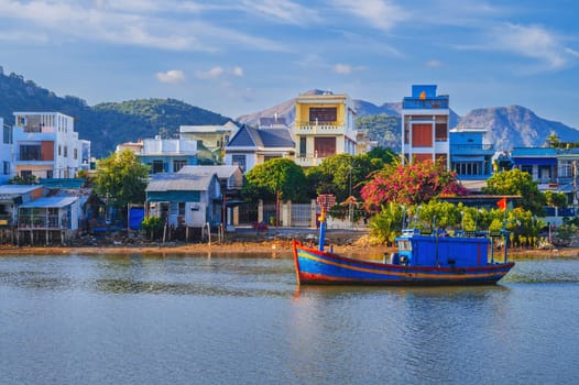 There are many traditional Vietnamese fishing boats and vessels in the bay on the river at Vinh Truong Fishing Port in Nha Trang, Vietnam