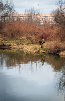 Shot of the man fishing on the winter river
