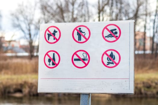 Close up shot of the information board in the park with restriction icons