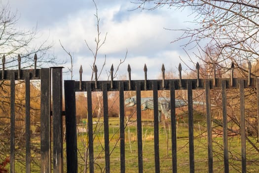 Shot of the dinosaur sculpture behind the fence