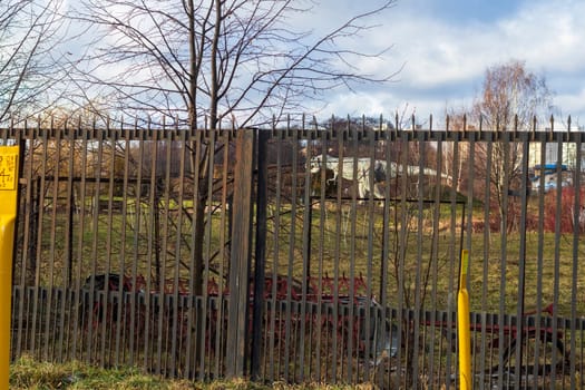 Shot of the dinosaur sculpture behind the fence