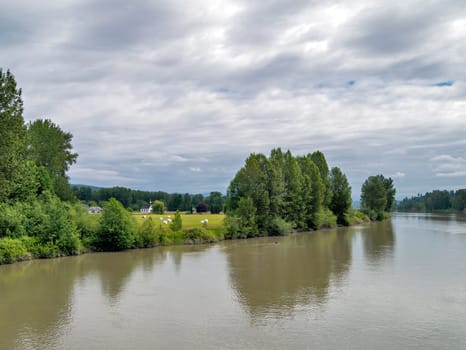A beautiful river landscape with a white church on the shore.