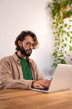 Cheerful male working with his laptop at home. High quality photo