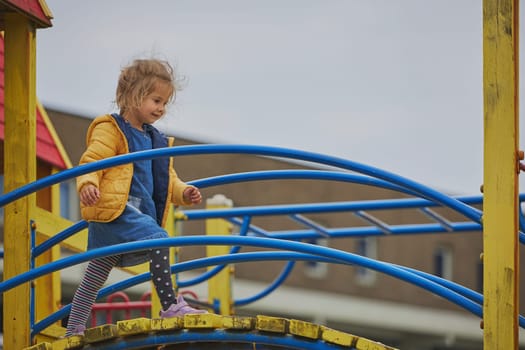 Charming child playing on a playground in Ringkobing Denmark.