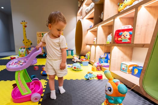 Child playing in a modern playroom filled with vibrant and interactive toys. Concept of engaging activities and early childhood education indoors