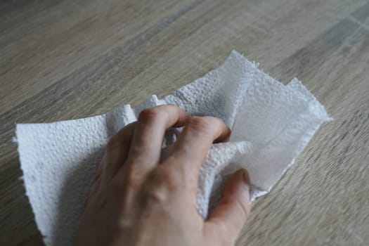 woman hand clean wipe tidy table kitchen paper towel cloth Ecology reusable recycle routine house. High quality photo