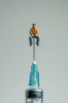The man is on a needle. A drug addict in a medical syringe with a needle on a white isolated background. The concept of combating drugs.