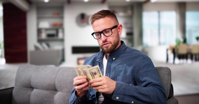 Man Holding Money. Counting Cash Dollar Bills
