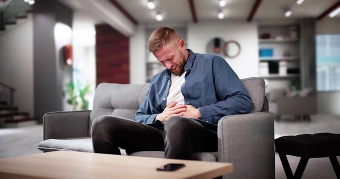Man With Heartburn And Nausea From Eating Fastfood