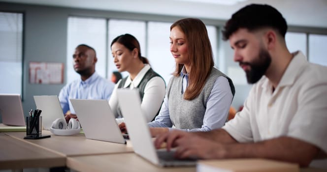 Diverse College Students Group In Classroom With Laptop Computers