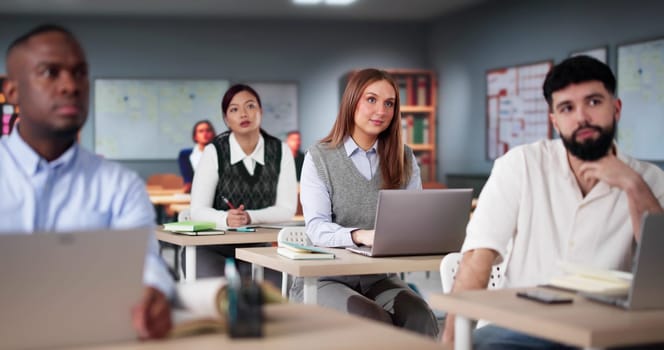 Diverse College Students Group In Classroom With Laptop Computers