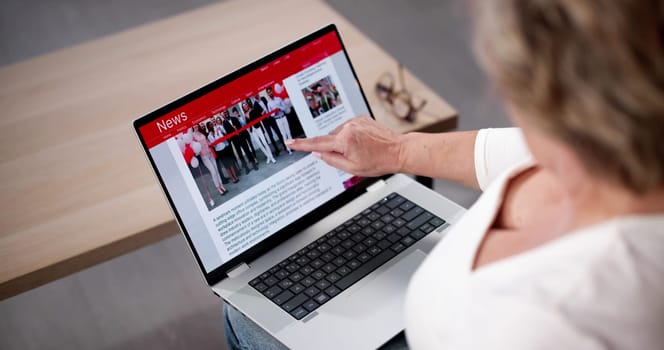 Watching Online News Article On Mobile Phone And Laptop