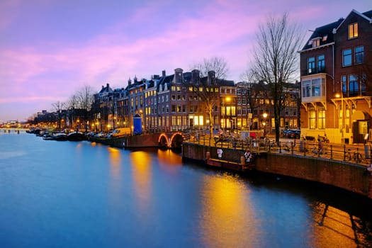 View on Amsterdam at the river Amstel at sunset in the Netherlands