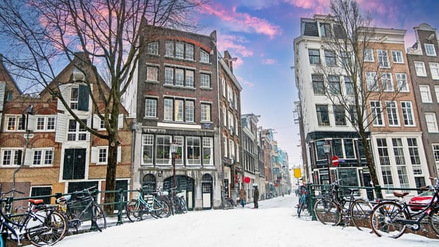 Snowy city Amsterdam in the Netherlands with the St. Nicolas church in winter