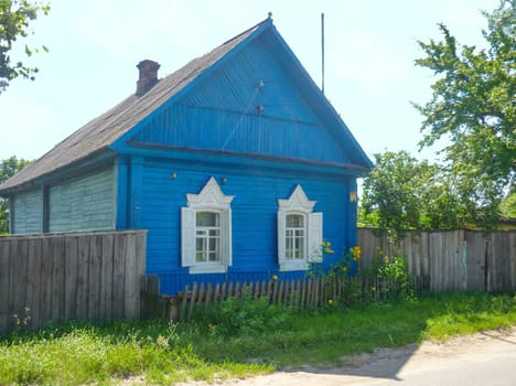 Russian blue hut in a village countryside