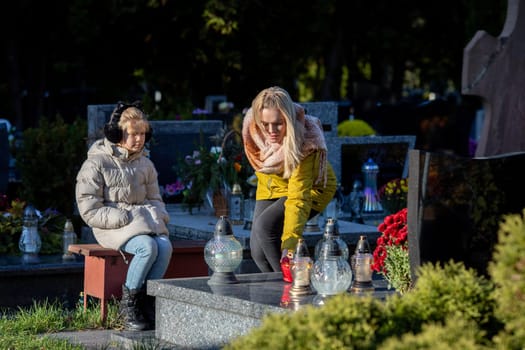 Women gathered together to pay homage at a grave, symbolizing their love, remembrance, and deep connection