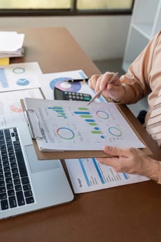 Analyzing key business metrics with detailed charts and graphs for strategic decision-making in a corporate setting.