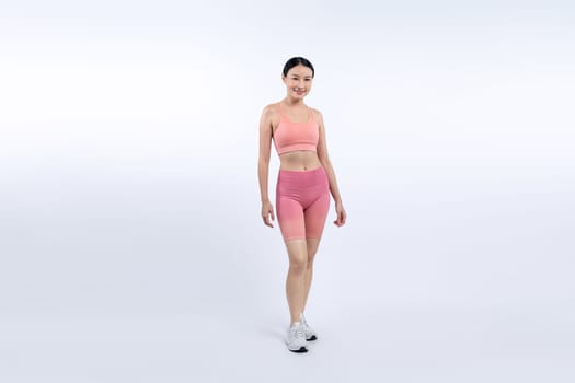 Full body asian woman in sportswear portrait, smiling and posing cheerful gesture. Workout training with attractive girl engage in her pursuit of healthy lifestyle. Isolated background Vigorous