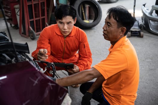 Automotive service mechanic inspect and diagnose car engine issue, repairing and fixing problem in garage workshop. Technician car care maintenance working on internal components of vehicle. Oxus