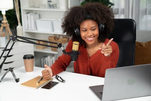 Host channel of beautiful African woman talking in online broadcast teaching marketing influencer, with listeners in broadcast or online. Concept of anywhere at work place. Tastemaker.