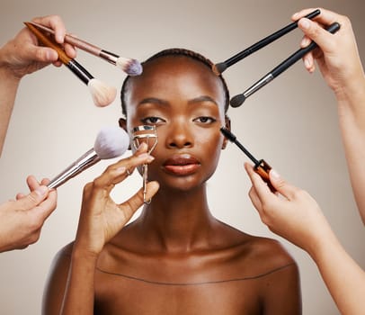 Tools, hands and portrait of black woman and cosmetics for getting ready, beauty product and glow. Brush, group and people with equipment for an African model, makeup and artist application in studio.